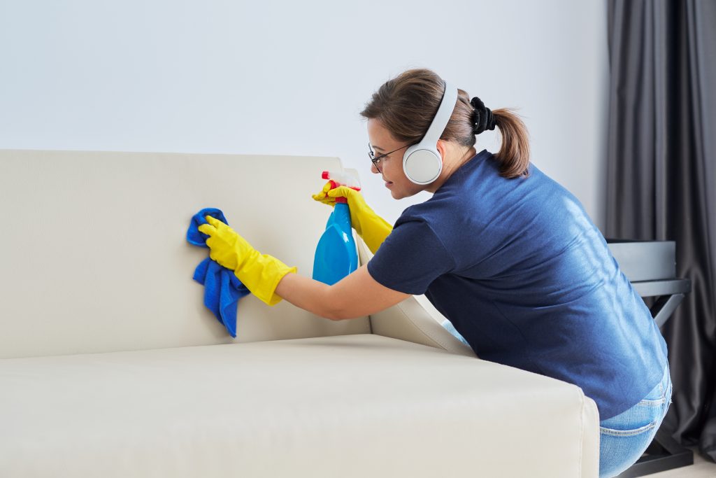 woman cleaning a sofa 